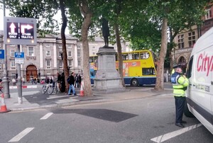 10/08/2015 Luas Cross City. Traffic restrictions kicked in this morning for works on the Luas Cross City service. Pictured, a Garda on College Green explains the new system to a confused motorist. Photograph: Mark Stedman / Rolling News