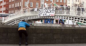 20/1/2017. Donald Trump banners. Pictured is Donald Trump banners on Hapenny Bridge in Dublin.Today Donald Trump’s Presidential inauguration was marked by the dropping of a banner from the Ha’penny bridge which reads “BRIDGES NOT WALLS – Love Trumps Hate. The events is one of scores of similar events across 3 continents in solidarity with people in the US who are likely to be the targets of the hate which has become associated with the Trump campaign.The action is coordinated by the European Network Against Racism Ireland (ENAR Ireland) and is supported by the Immigrant Council of Ireland, The Union of Students in Ireland (USI), the Migrant Rights Centre Ireland (MRCI) and other ENAR Ireland network members. Photo:Leah Farrell/RollingNews.ie